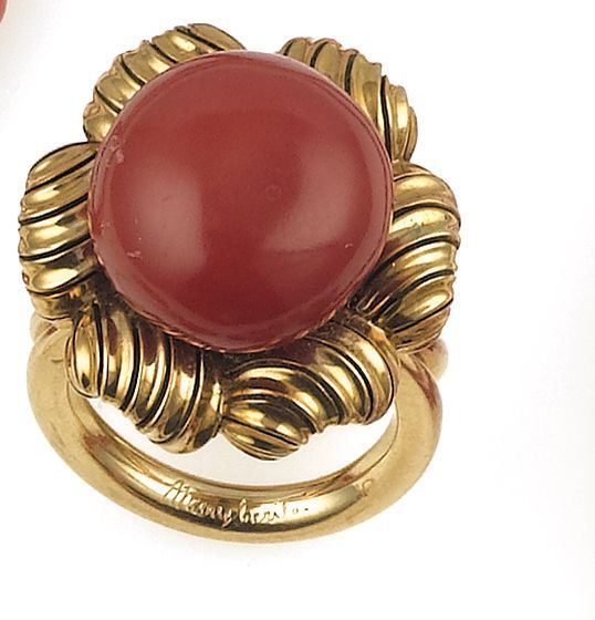 A gold and coral ring