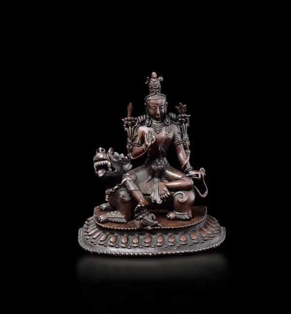 A Shi shou copper figure of Amitayus with silver inlays seated on Pho dog, China, Qing Dynasty, 18th century