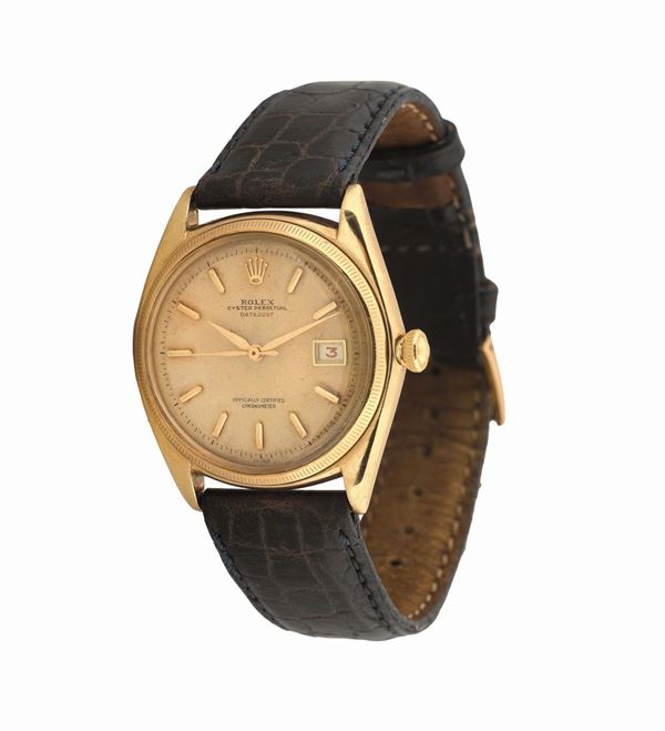 ROLEX, Oyster Perpetual, Datejust, Officially Certified Chronometer, Ref. 4467. Made in the 1950's. Very fine and rare, center-seconds, self-winding, water-resistant, tonneau-shaped,  yellow gold wristwatch with date and a gold-plated Rolex buckle.
