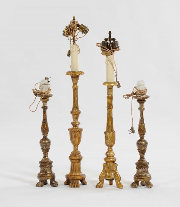 Lotto di quattro reggicero in legno intagliato e dorato, XVIII-XIX secolo