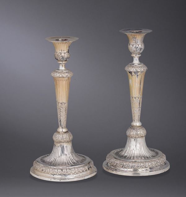 A pair of silver candelsticks, first half of the 19th century, guarantee mark (Mauritian cross) and territory mark (coiled dolphin).