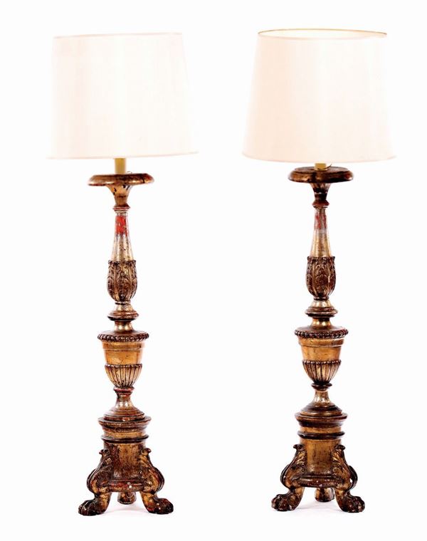 A pair of neoclassical silvered wooden candelstick lamps, early 19th century