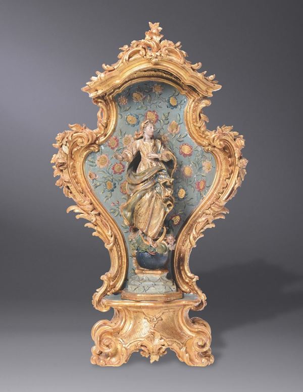 A wooden Madonna sculpture within a wooden, golden, painted niche. Mid 18th century Genoese sculptor.