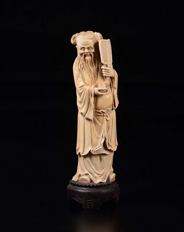 A carved ivory figure of wise man with fan, China, early 20th century