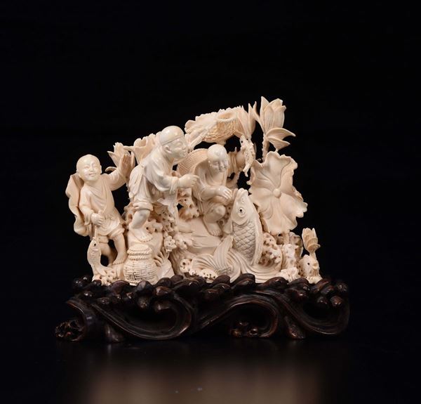 A carved ivory children with fish and flowers group, China, early 20th century