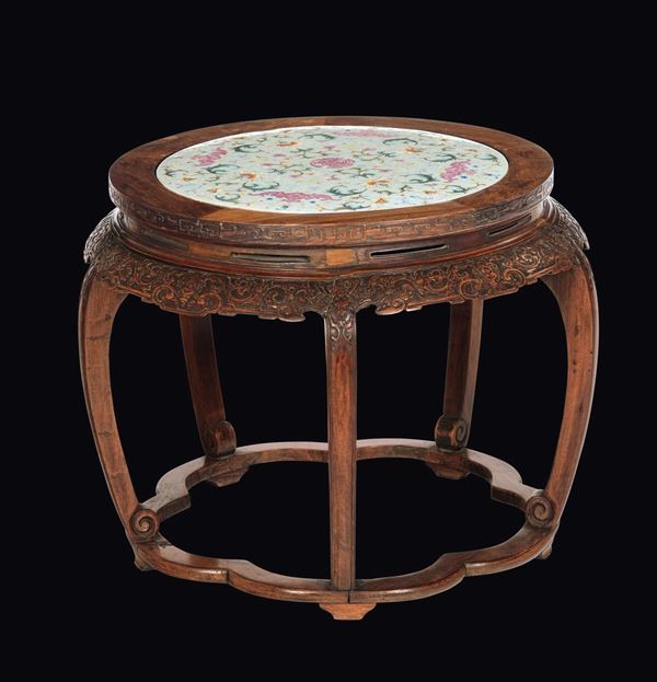 A wooden stool with a Famille-Rose plaque with bats on the top, China, Qing Dynasty, 19th century