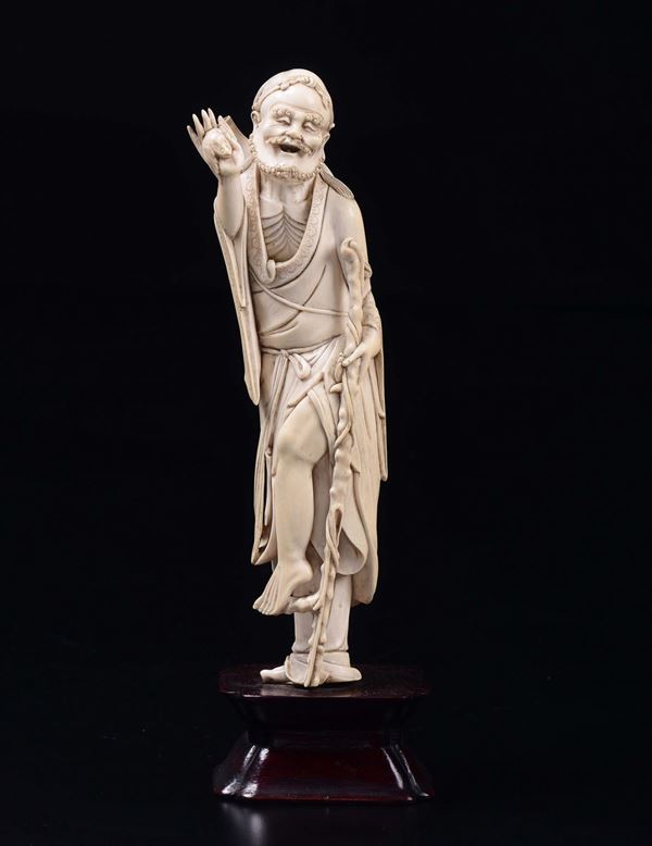 A carved ivory figure of wise man with stick, China, early 20th century