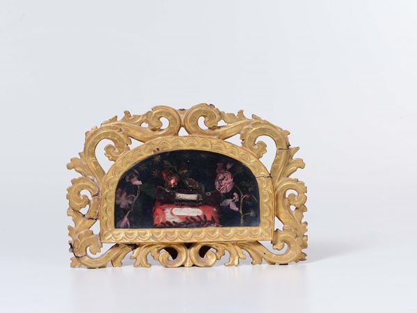 Teca in reliquia di un corporale di San Benigno in cornice intagliata e dorata. Italia fine XVIII secolo