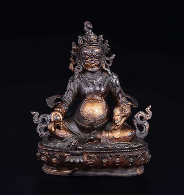 A semi-gilt bronze figure of deity seated on a lotus flower, China, 20th century