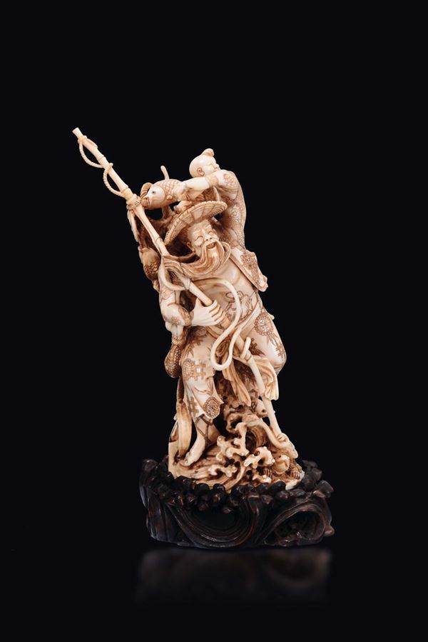 A carved ivory figure of fisherman with fishing pole and child on his back, China, Qing Dynasty, late 19th century