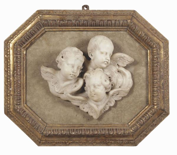 A group of white marble Cherub heads within a wooden frame. 17th-18th century Genoese baroque art