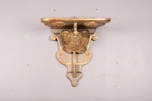 Grande mensola in legno laccato e dorato con testa di putto, XIX secolo