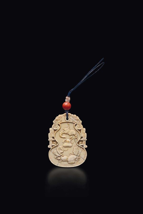 A rare Imperial carved ivory pendant with peaches and inscriptions, China, Beijing, Qing Dynasty, 18th century