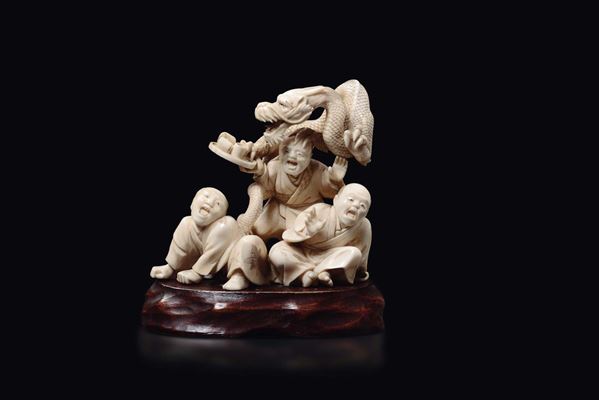 A carved ivory group with men and dragon, Japan, early 20th century