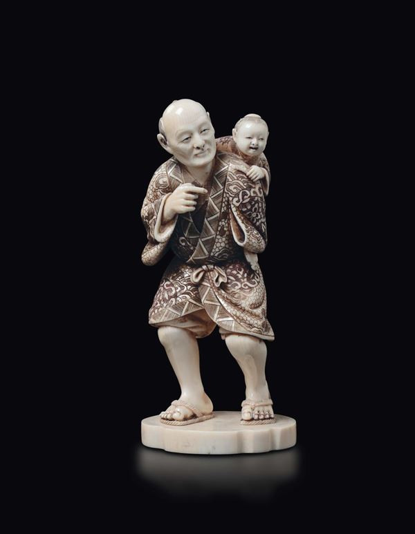 A carved ivory figure of peasant with child on the shoulders, Japan, early 20th century