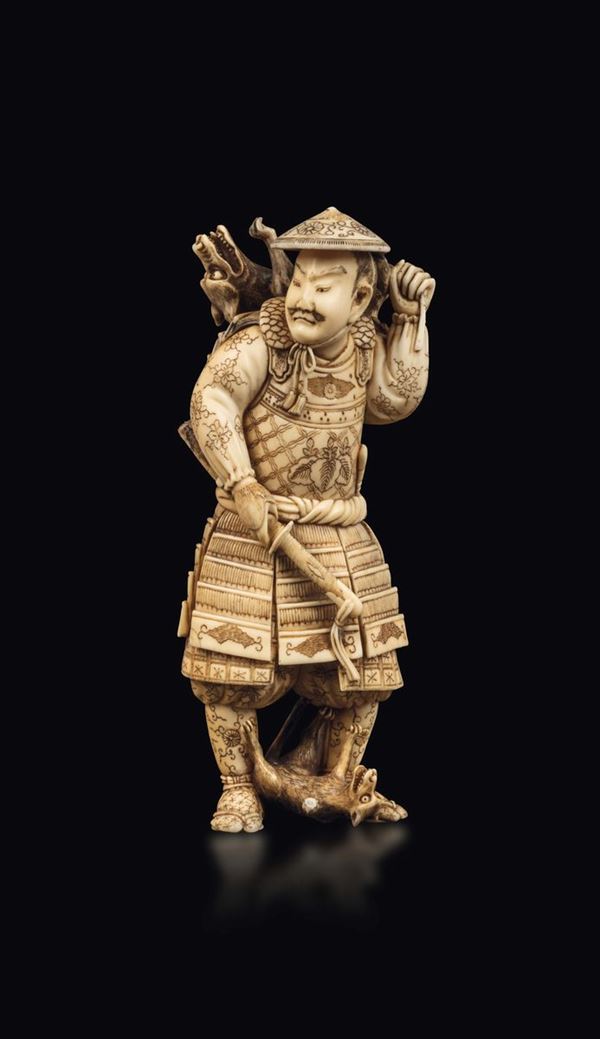 A carved ivory figure of hunter with dogs, Japan, early 20th century