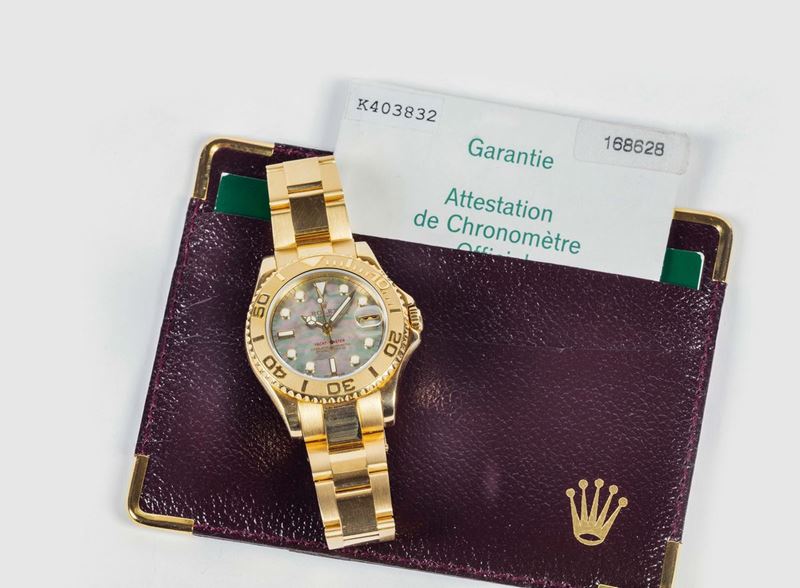 ROLEX -Oyster Perpetual Date, Yacht-Master, Superlative Chronometer, Officially Certified, case No. K403832, REF. 168628 - MOTHER OF PEARL. Very fine, center seconds, self-winding, water-resistant, 18K yellow gold wristwatch with special time-lapse bezel, date and an 18K yellow gold Rolex Oysterlock bracelet Ref. 78753. Accompanied by the original fitted box, guarantee. Sold in 2005  - Auction Watches and Pocket Watches - Cambi Casa d'Aste