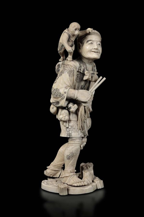 A carved ivory figure of peasant with monkey on his shoulder, Japan, early 20th century
