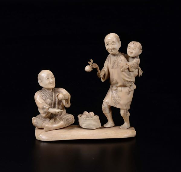 A carved ivory group of peasants and child, Japan, early 20th century