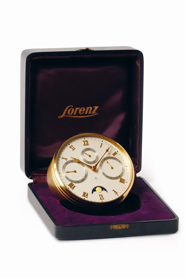 LORENZ, rare, 8 days power reserve, gilted brass table clock with calendar, moon phase and alarm. Accompanied by the original box. Made circa 1950