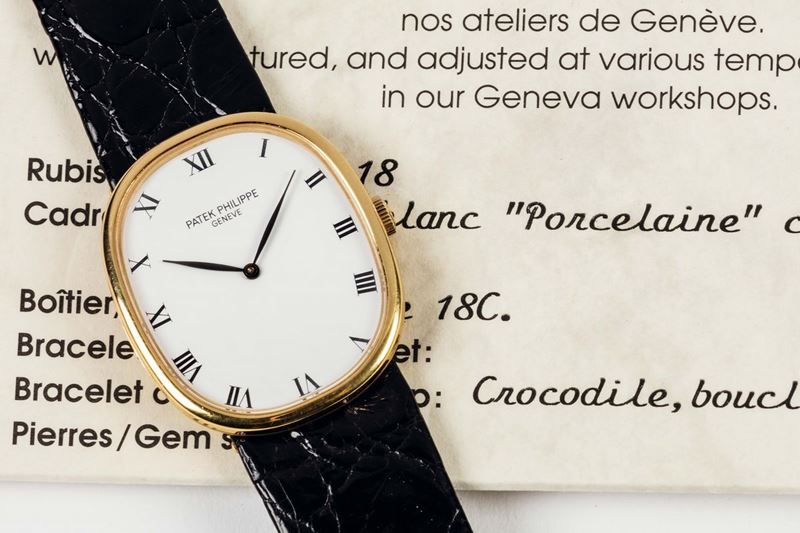PATEK PHILIPPE, ELLIPSE, REF. 3848, PORCELAIN DIAL, movement No. 1340180, 18K yellow gold wristwatch with porcelain dial and original gold buckle. Accompanied by the original box and Certificate. Sold in 1993  - Auction Watches and Pocket Watches - Cambi Casa d'Aste