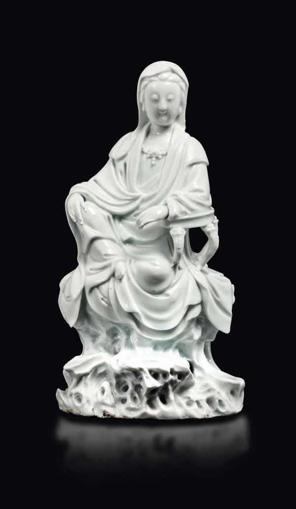 A Dehua figure of Guanyin seated on a rock, China, Qing Dynasty, 18th century