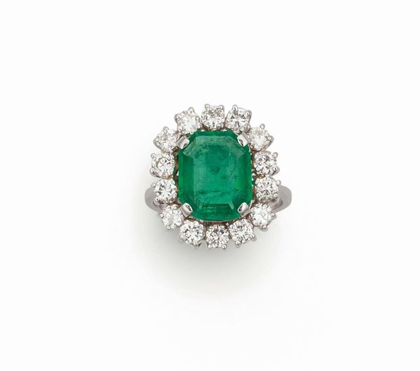 Emerald and diamond cluster ring set in white gold