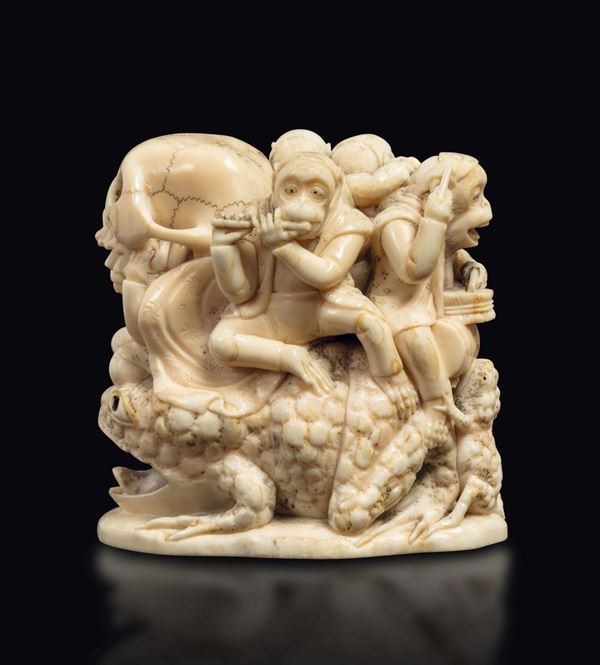 A carved ivory playing monkeys and skull on a frog group, Japan, Meiji Period, late 19th century