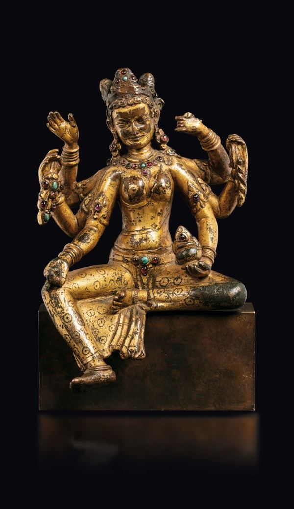A gilt bronze figure of Vasudhara with semi-precious stone inlays, Nepal, 14th century