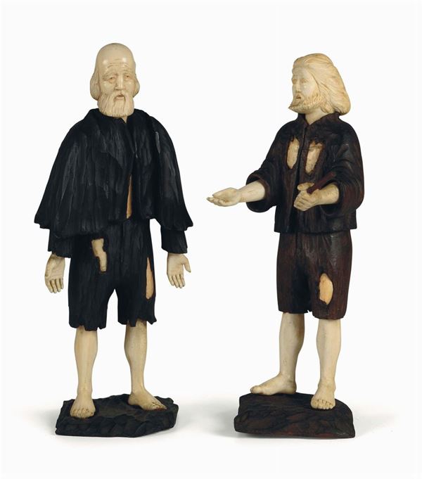 A pair of wooden and ivory sculptures with beggars, Germany, 19th century, height cm 28