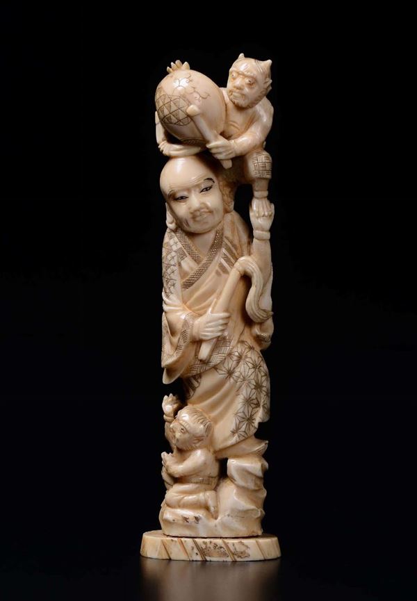 A carved ivory figure of wise man with children, Japan, early 20th century