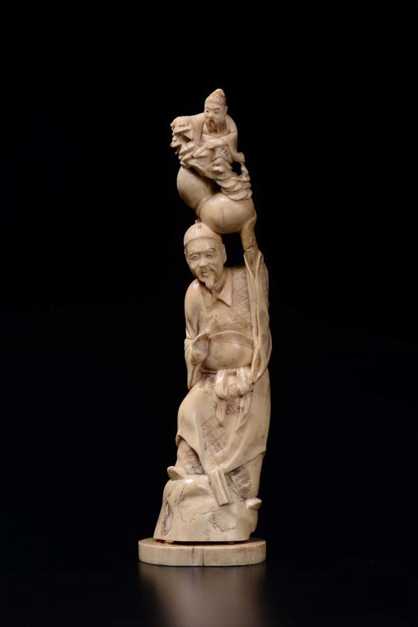 A carved ivory wise man with children group, China, early 20th century