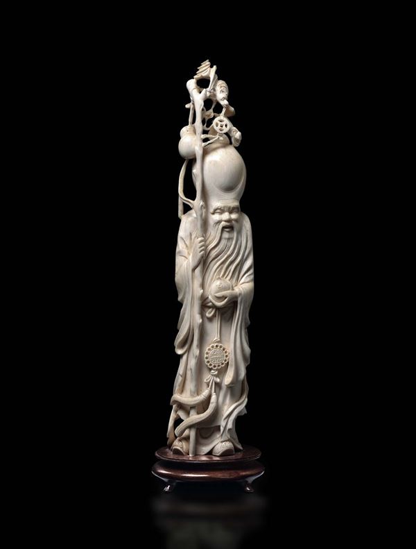 A carved ivory figure of Shoulao with stick, China, early 20th century