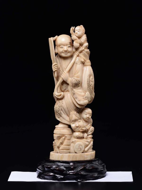 A carved ivory group with wise man and children, China, early 20th century