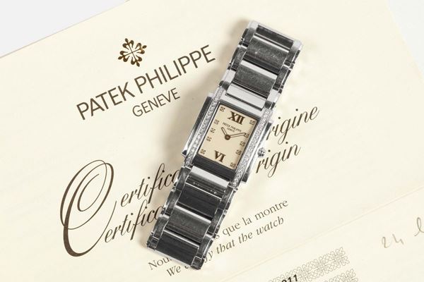 PATEK PHILIPPE, Geneve, REF. 4910, TWENTY-FOUR, LADY'S QUARTZ STEEL & DIAMOND. Made in the 2000s. Fine, rectangular curved, water-resistant, stainless steel and diamond lady's quartz wristwatch with a stainless steel integral link Patek Philippe bracelet with double deployant clasp. Accompanied by the Certificate