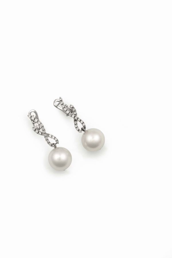 A pair of cultured pearl and diamond pendent earrings