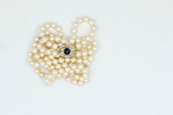 Two row of cultured pearls necklace with a sapphire, diamond and gold clasp