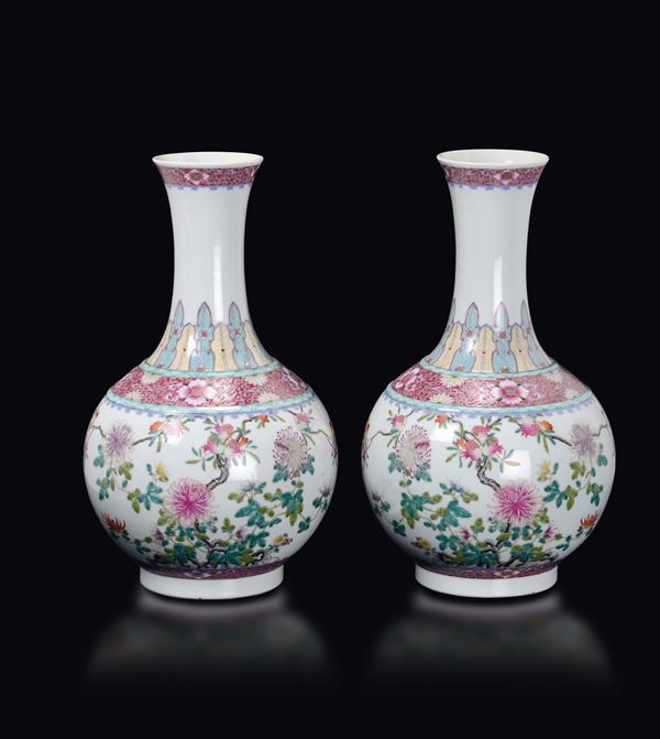 A pair of polychrome enamelled porcelain vases with peach branches with flower and fruits, China, early 20th century
