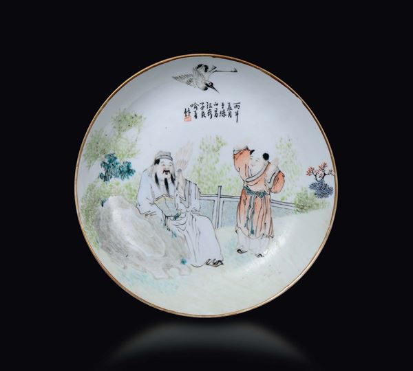 A polychrome enamelled porcelain dish with wise man and children and inscription, China, Qing Dynasty, 19th century
