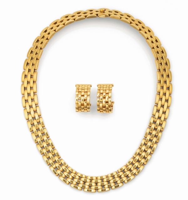 Suite consisting of a necklace and a pair of earrings set in yellow gold, Cartier