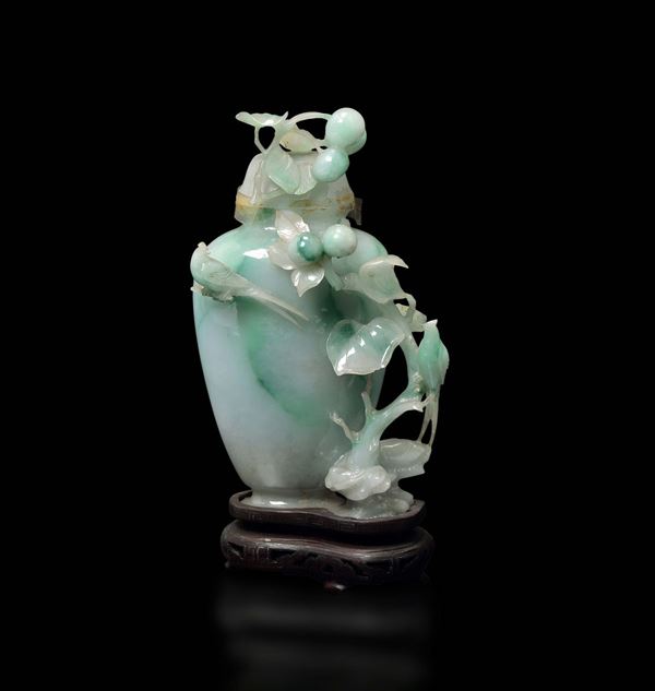 A small apple green shades jadeite vase and cover with peaches and birds in relief, China, early 20th century