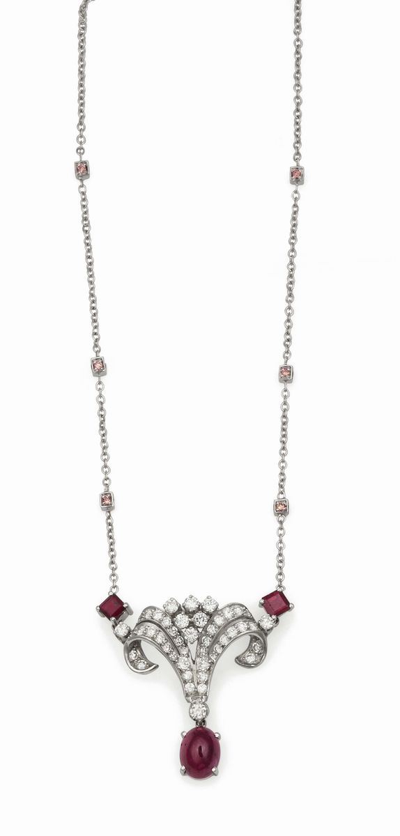 A platinum pendant set with a cabochon-cut ruby and diamond