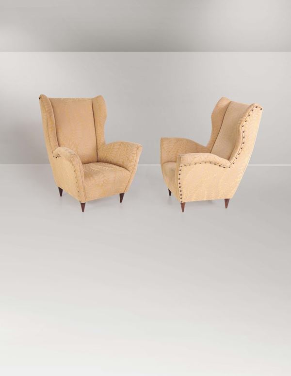 A pair of wooden upholstered armchairs