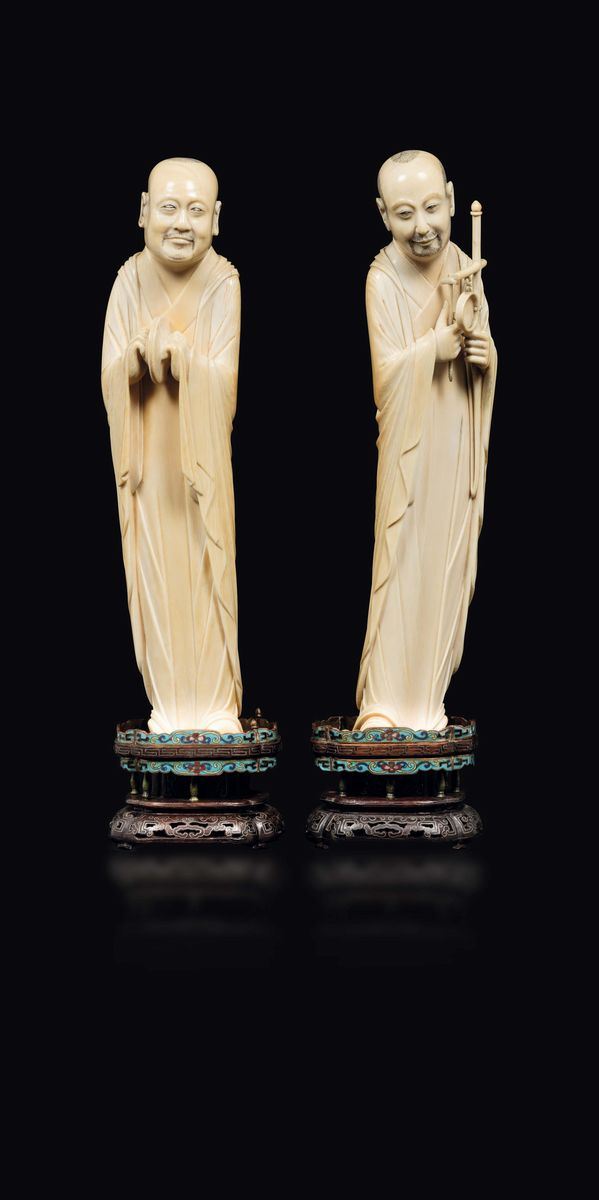 A pair of carved ivory figures of musicians with wooden and cloisonné stands, China, Qing Dynasty, 19th century