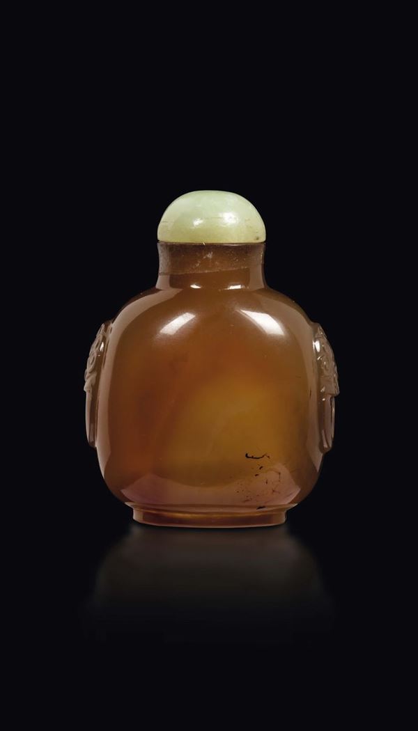 A moss agate snuff bottle with mask handles and jade stopper, China, Qing Dynasty, 19th century