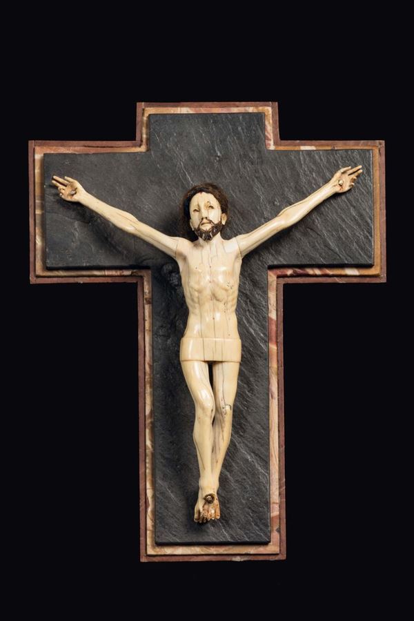 A carved ivory figure of Christ crucified on a slate and marble cross, Goa, 18th century