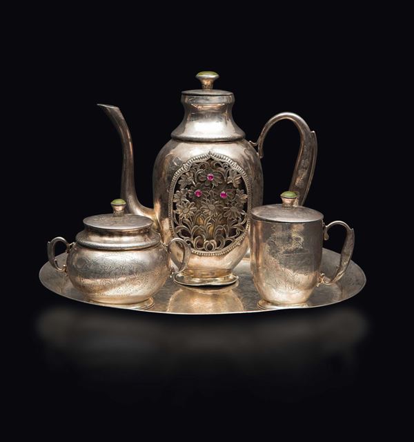 A silver tea set with tray: a fretworked with ruby inlays teapot, a sugar bowl and a milk jug, China, Qing Dynasty, 19th century