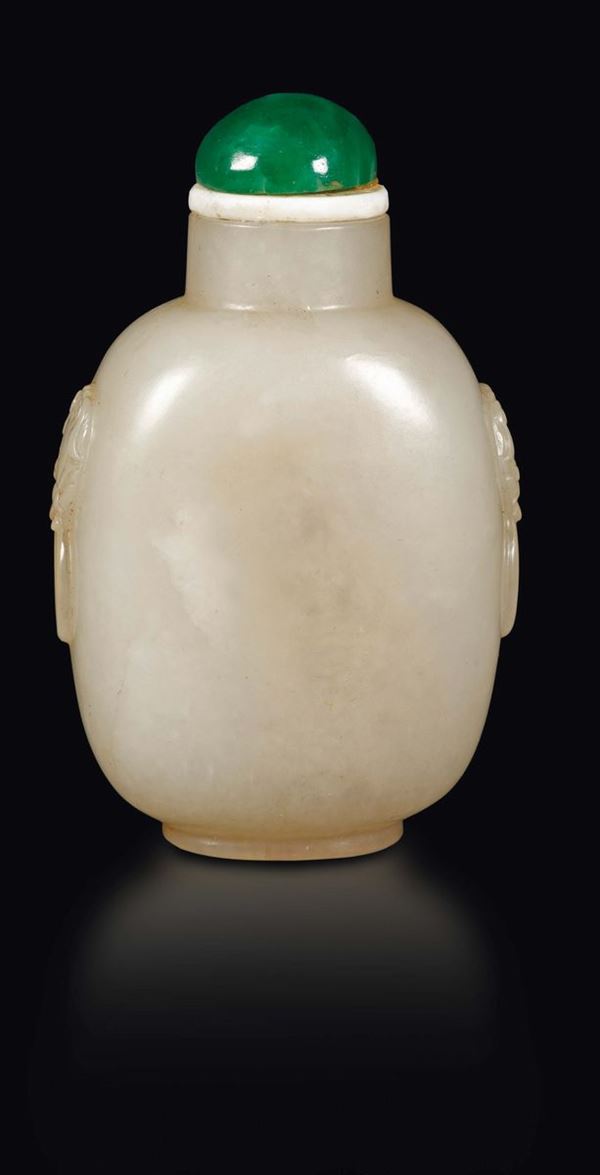 A white and russet jade snuff bottle with mask handles, China, Qing Dynasty, 19th century