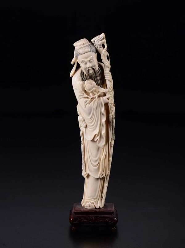 A carved ivory figure of wise man with stick, China, early 20th century