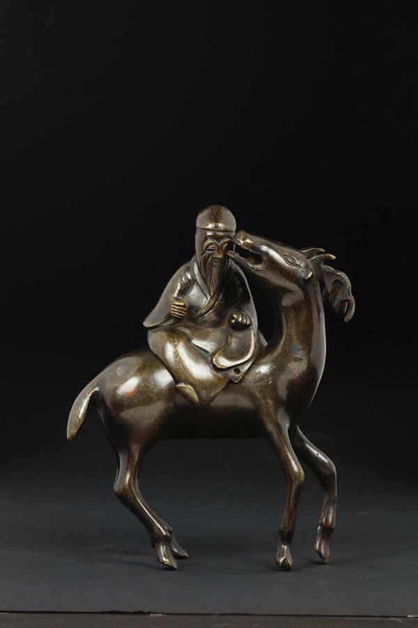 A bronze Shi sou censer with wiseman on a fawn, China, Qing Dynasty, 18th century